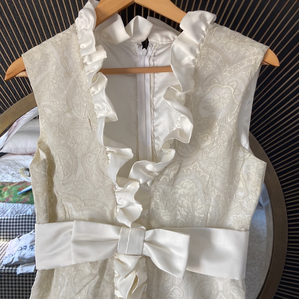 Custom made ivory tone on tone sleeveless dress with satin ruffle and bow. - Picture 3 of 7